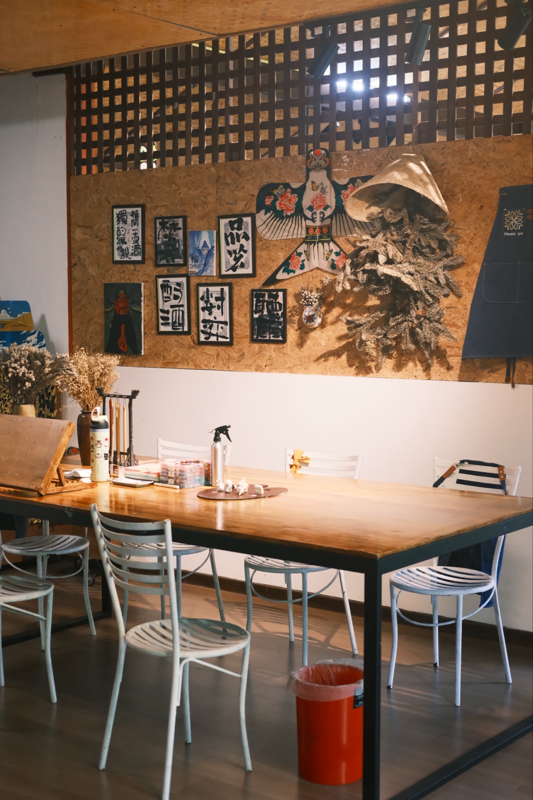Pimalai Spa’s shared craft table and wall of Chinese calligraphy and artwork
